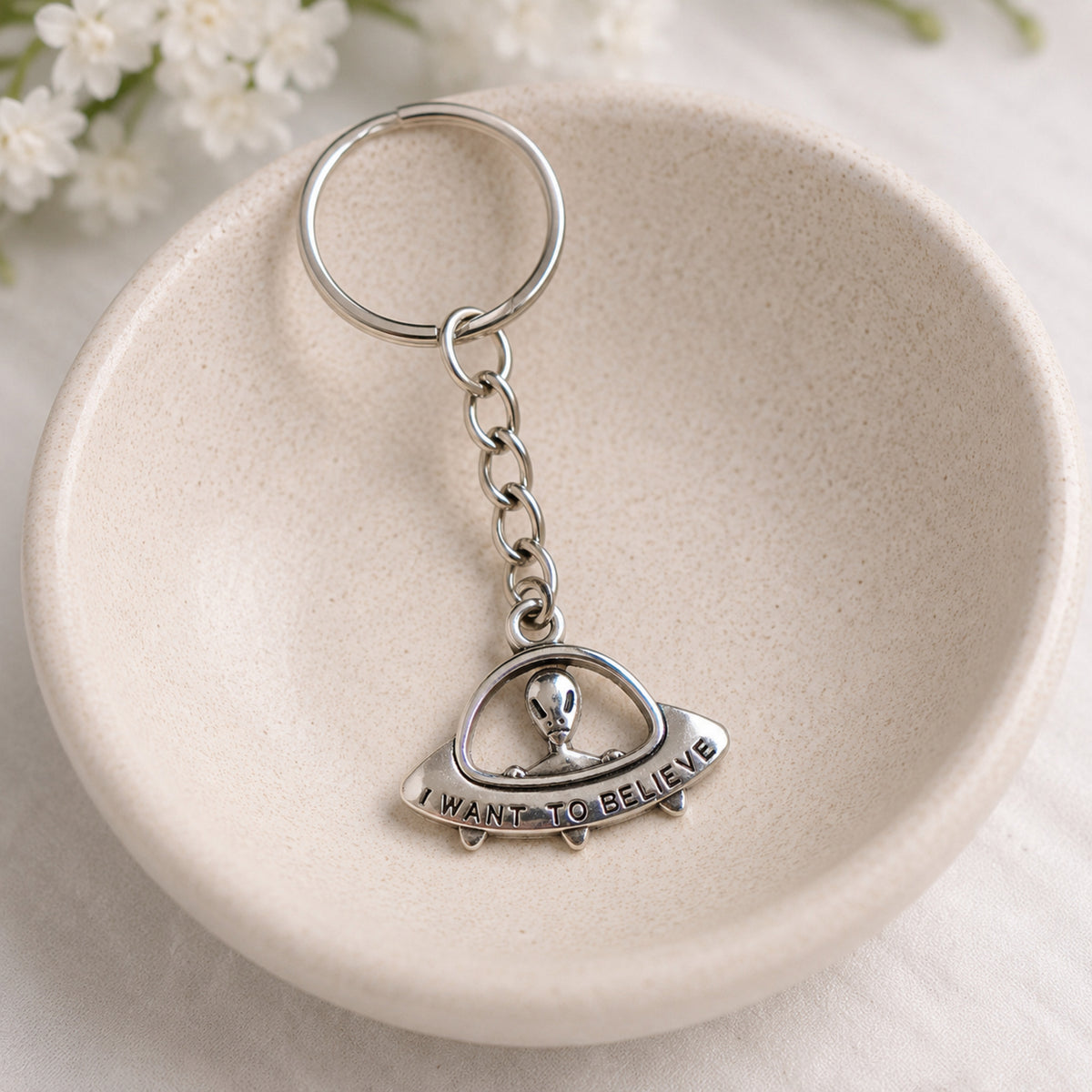 UFO Believe Keyring and Bag Charm styled in a ceramic bowl