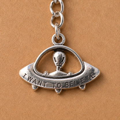 Close up of silver UFO Believe Keyring and Bag Charm