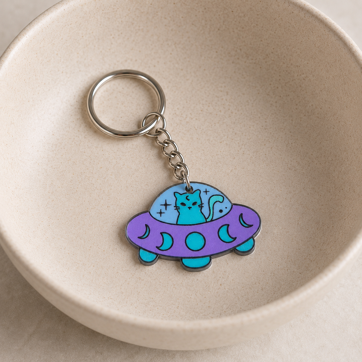UFO Space Kitty Keyring / Bag Charm displayed in a lifestyle bowl photo