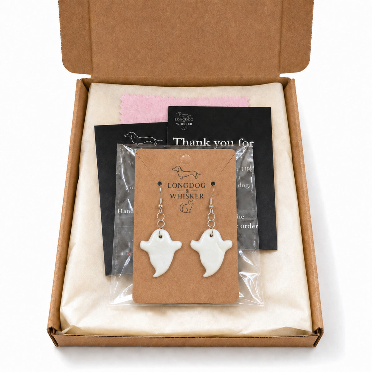 White ghost earrings shown with Longdog & Whisker packaging