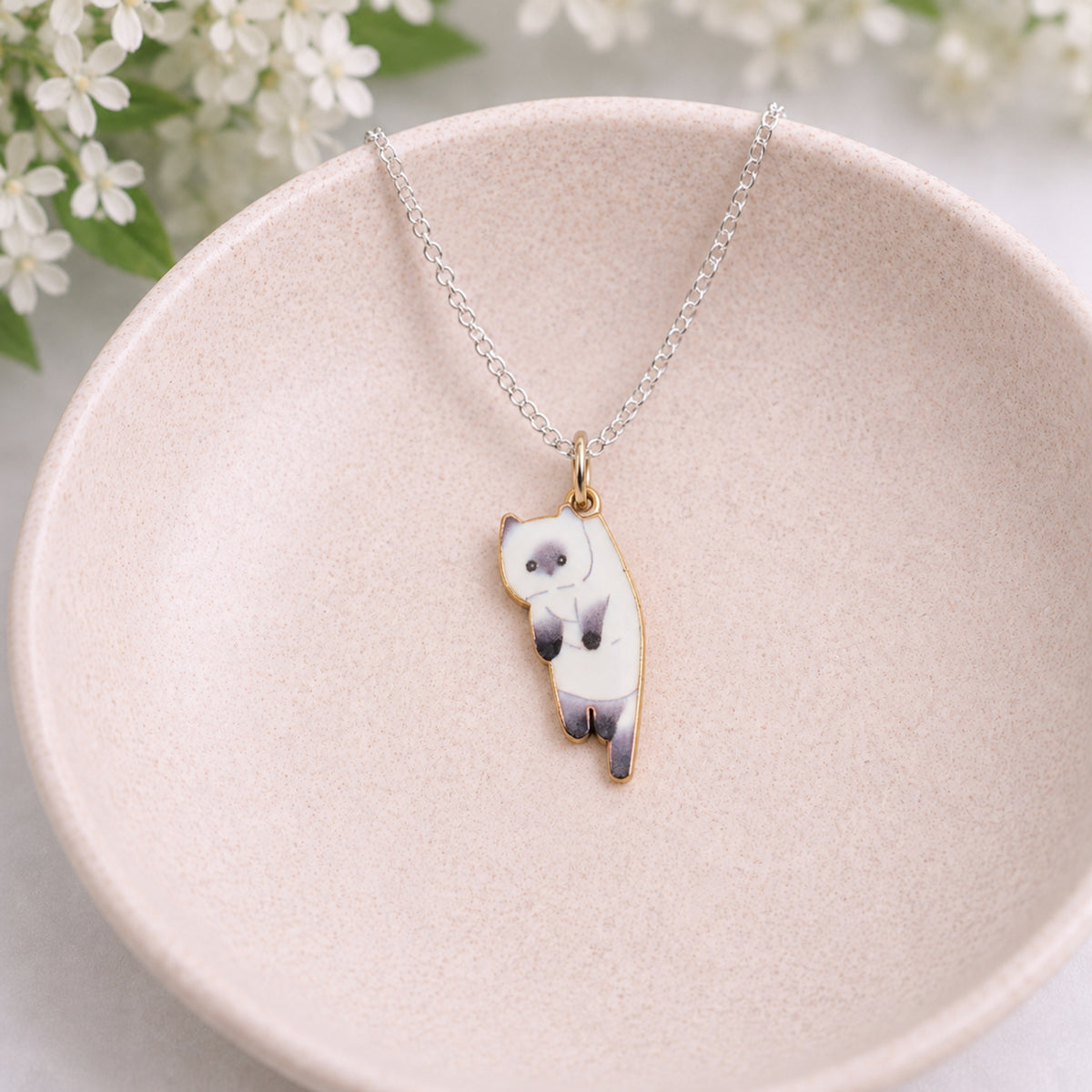 Scruffles Cat Necklace - White displayed in a lifestyle product photo