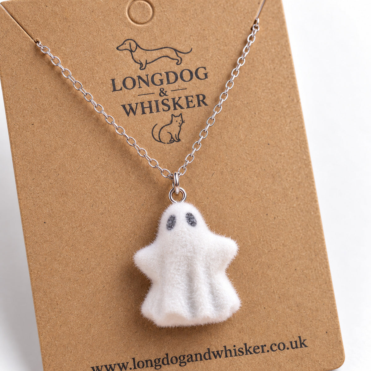 Close-up of Woooo Ghost Necklace charm and silver chain