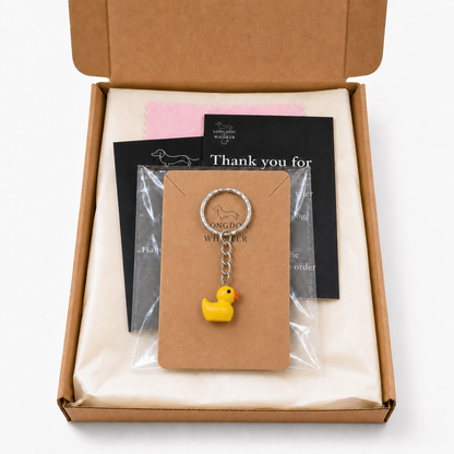 Yellow duck keyring on its Longdog & Whisker display card inside gift packaging