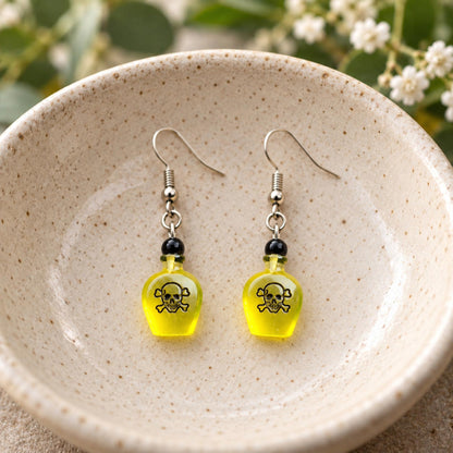 Yellow Poison Bottle Drop Earrings shown in display bowl
