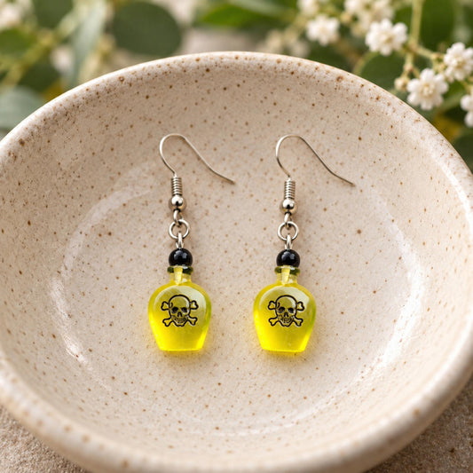 Yellow Poison Bottle Drop Earrings shown in display bowl
