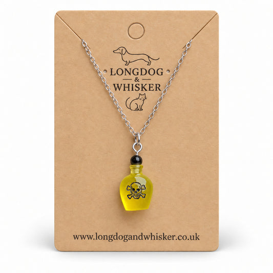 Yellow poison bottle necklace with silver chain on a Longdog & Whisker kraft card.