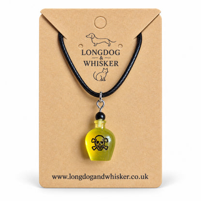 Yellow poison bottle necklace on black cord displayed on a Longdog & Whisker kraft card.