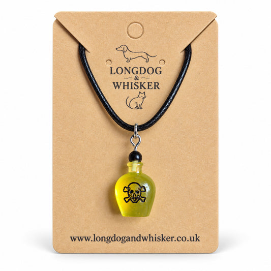 Yellow poison bottle necklace on black cord displayed on a Longdog & Whisker kraft card.