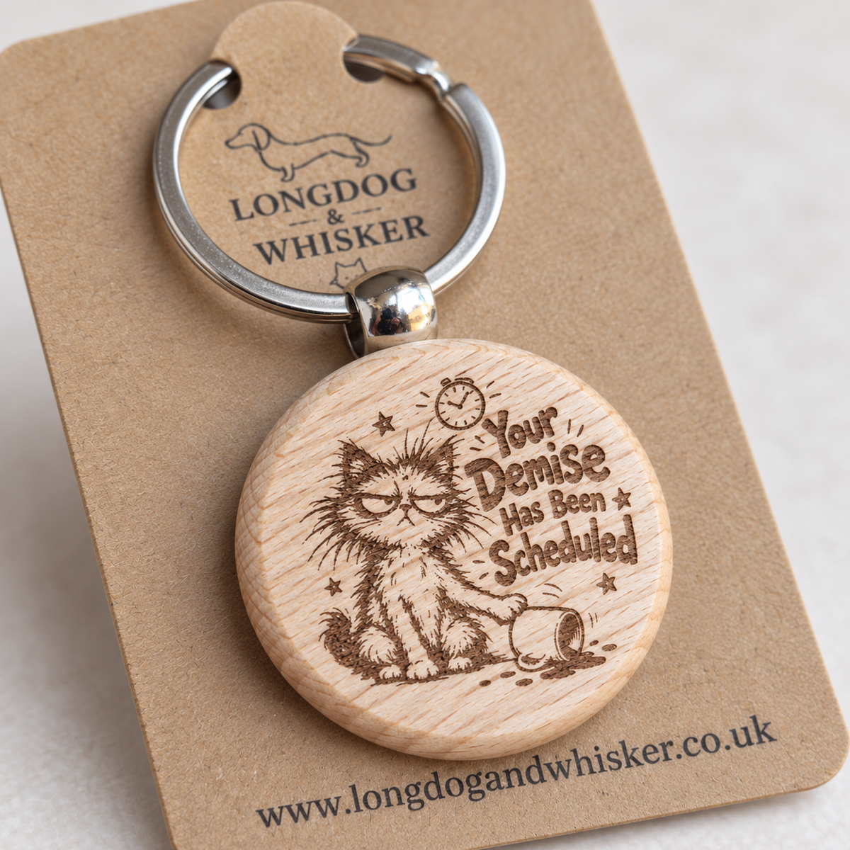 Close-up of Your Demise Has Been Scheduled cat engraving and rounded wooden keyring edge